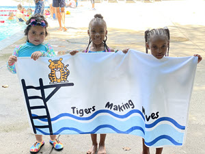 photo of students holding up a towel that says tigers making waves